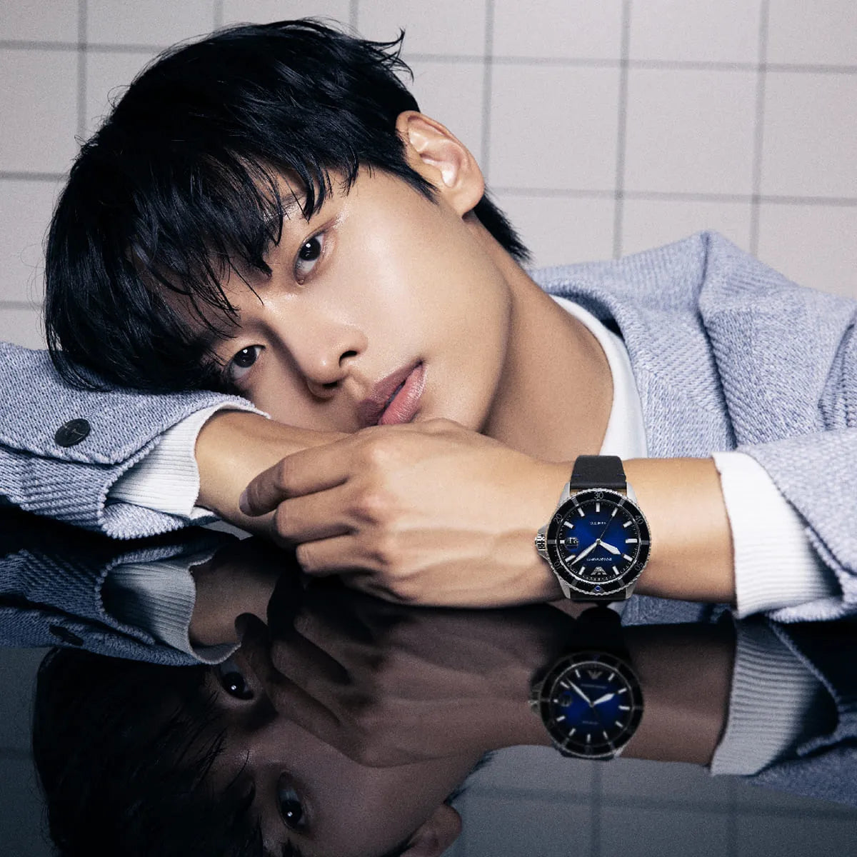 Emporio Armani AR11516 watch worn on man's wrist displaying blue dial face