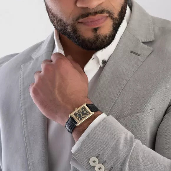 Man wearing Emporio Armani Gino watch with gold case and black strap paired with gray blazer