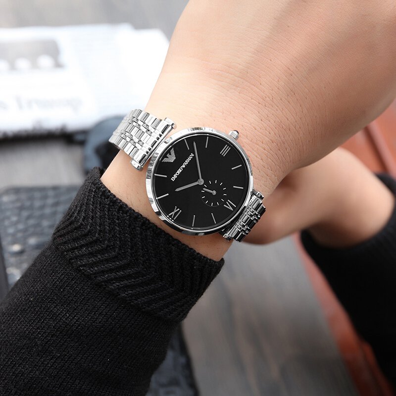 Emporio Armani AR1676 watch worn on wrist showing black dial and silver bracelet fit