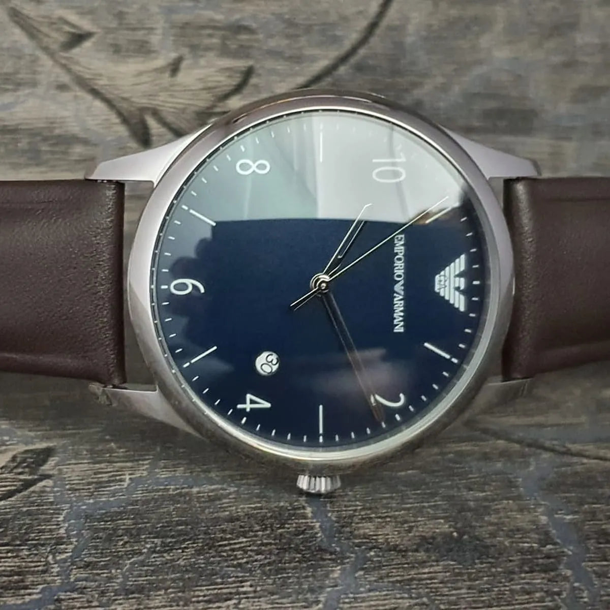 Emporio Armani AR1944 watch worn on wrist showing blue dial and brown leather strap