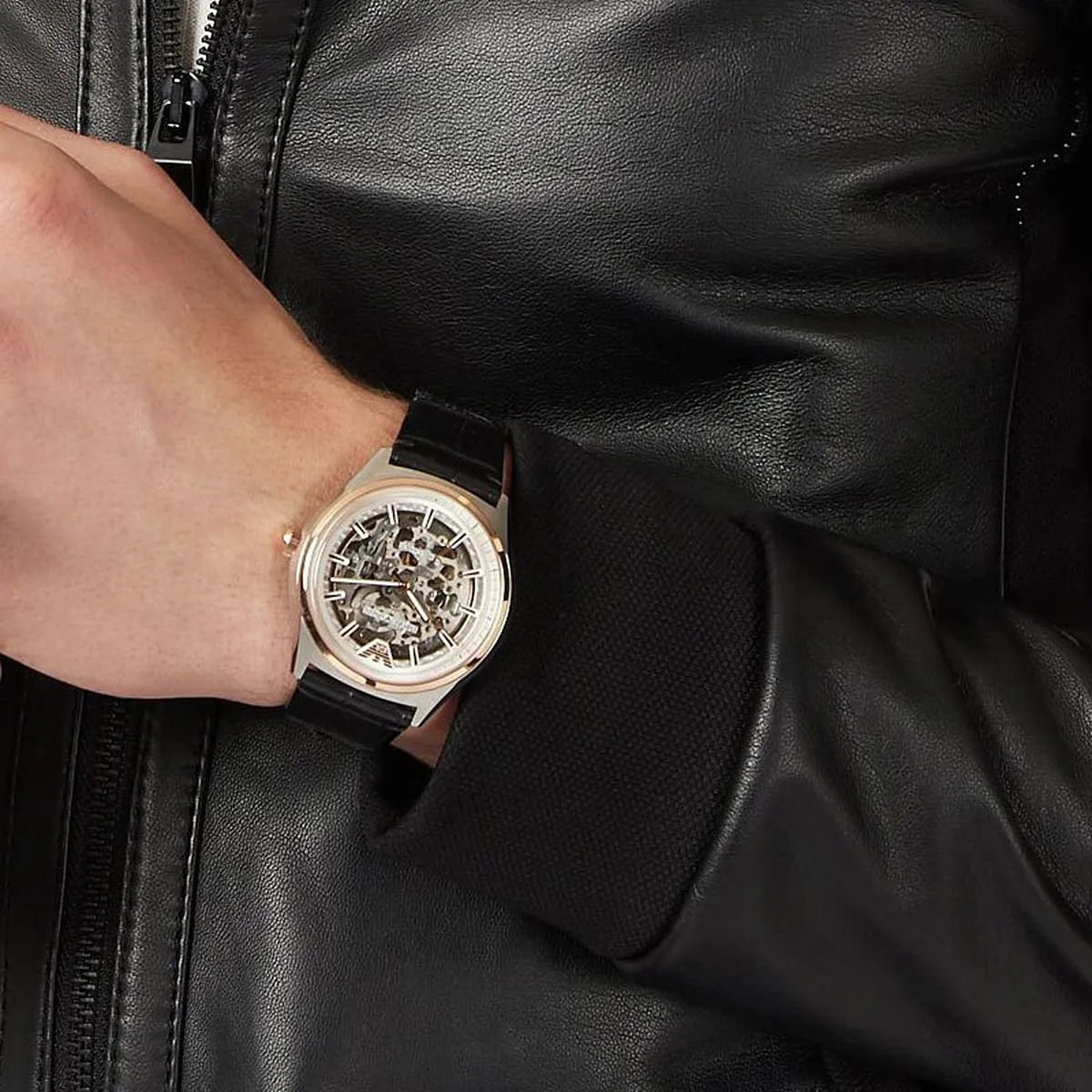 Emporio Armani AR60018 skeleton watch worn on wrist with black leather strap