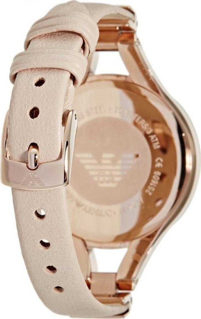 Rose gold watch case with cream leather strap showing buckle mechanism
