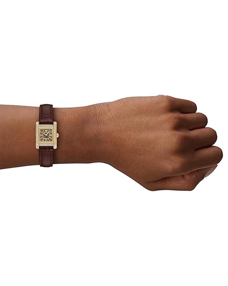 Emporio Armani Genni AR11705 women's watch worn on wrist showing gold rectangular case and brown leather strap
