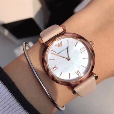 Emporio Armani Gianni women's watch worn on wrist with blush strap