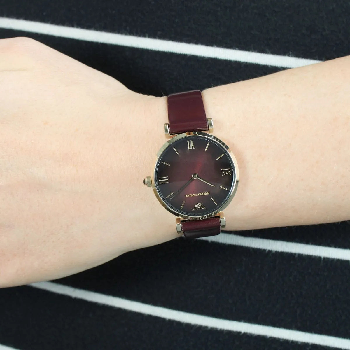 Emporio Armani Gianni AR1757 women's watch on wrist with burgundy leather strap