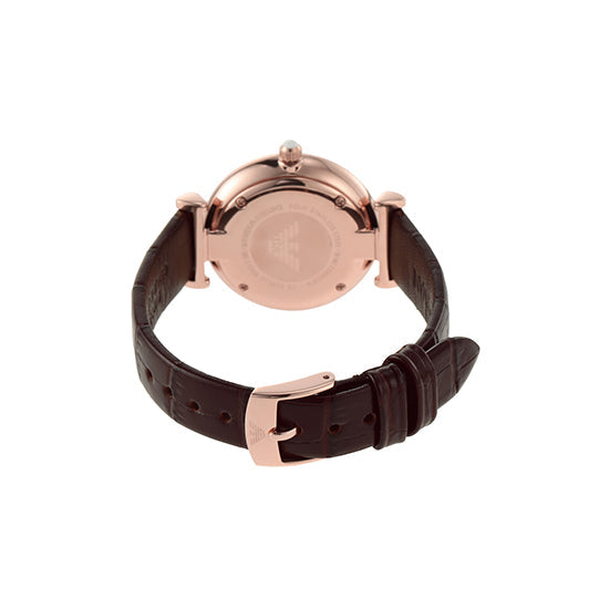 Back view of rose gold watch case with dark brown leather strap showing T-bar attachment