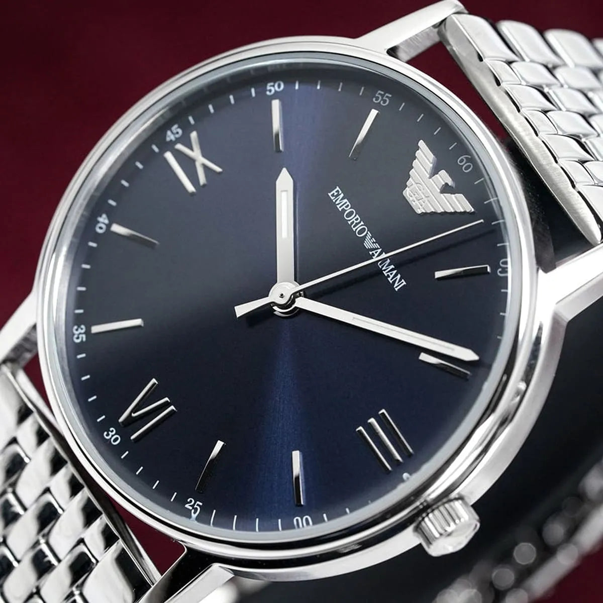 Close-up detail of Emporio Armani Kappa blue dial with Roman numerals and white hands