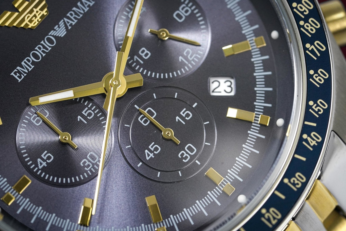 Emporio Armani Tazio AR8030 dial detail showing chronograph subdials, blue face, and gold hands