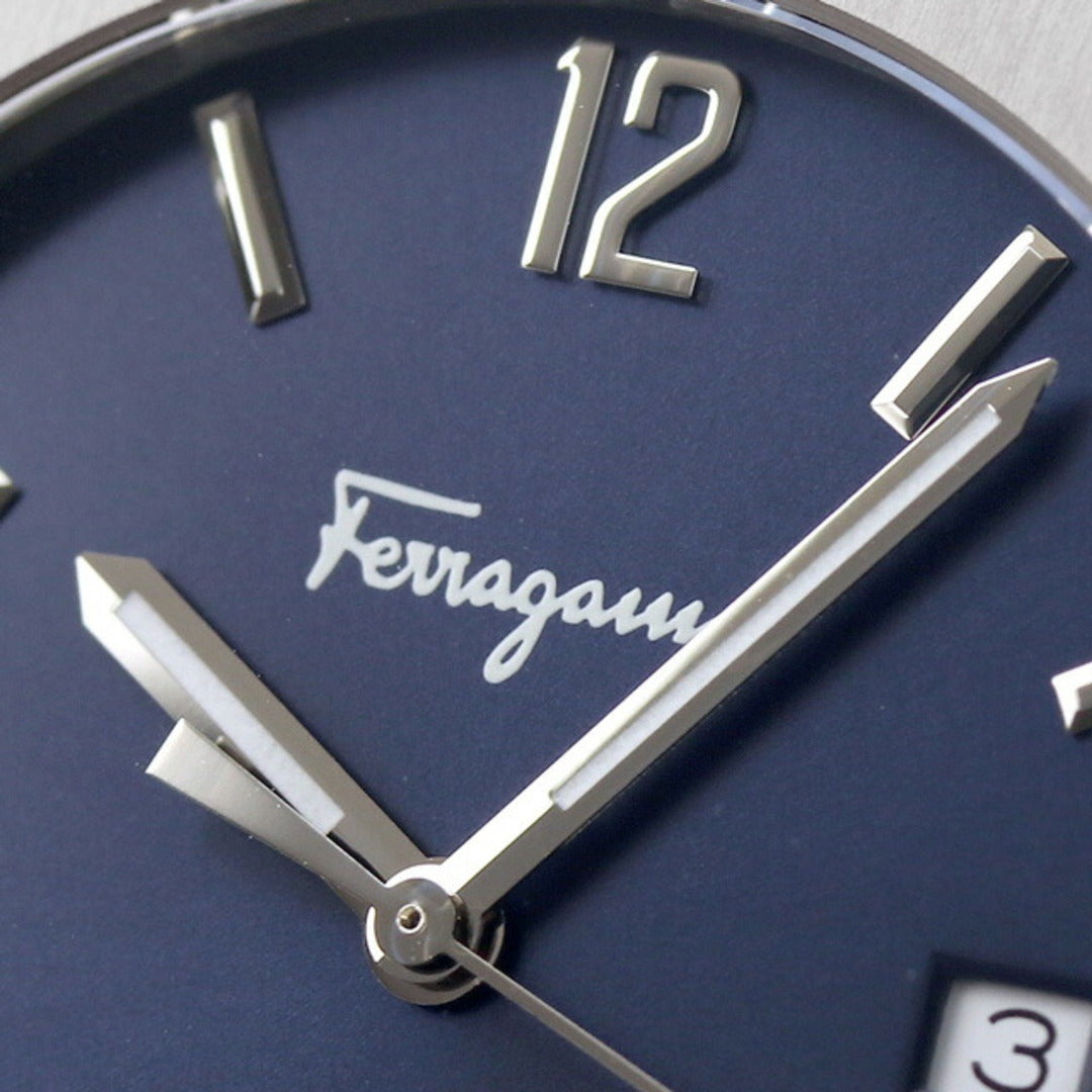 Blue dial close-up showing Ferragamo logo, hour markers, and white hands