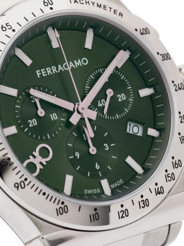Close-up of green chronograph dial with tachymeter scale and date window