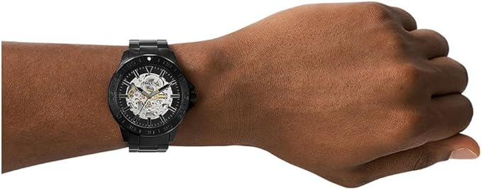 Fossil Bannon automatic watch worn on wrist showing black case and bracelet fit