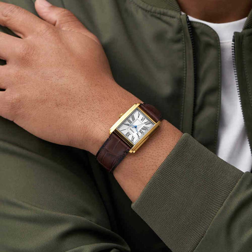 Fossil Carraway watch worn on wrist, displaying rectangular gold case with white dial and brown leather strap