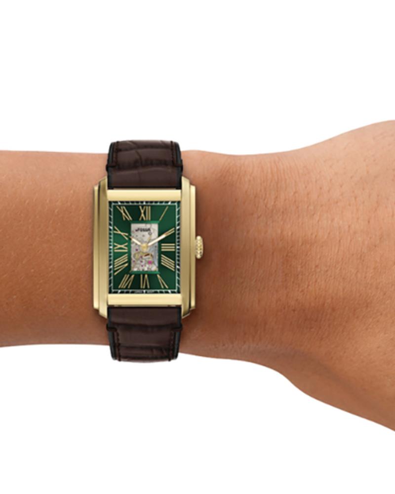 Fossil Carraway automatic watch on wrist showing green dial with Roman numerals and gold-tone rectangular case
