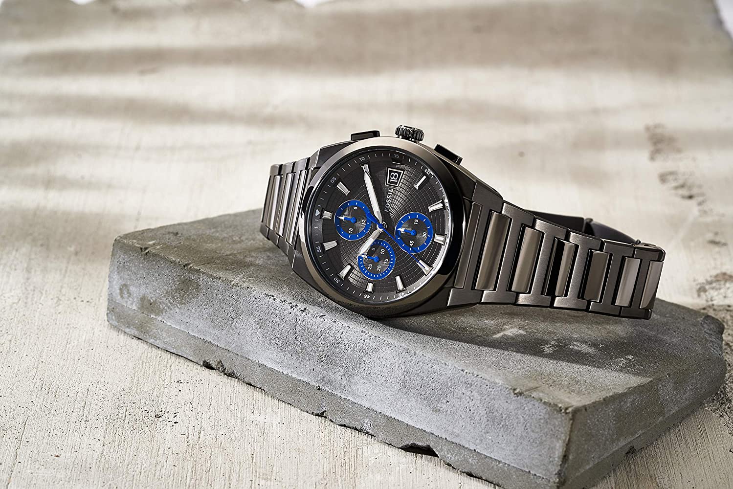 Fossil Everett chronograph watch worn on wrist, grey dial with blue subdials visible