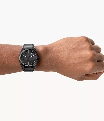 Fossil Everett black watch worn on wrist with black bracelet strap