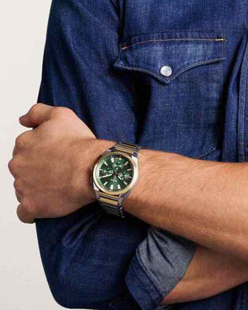 Fossil Everett two-tone chronograph watch worn on male wrist with denim shirt