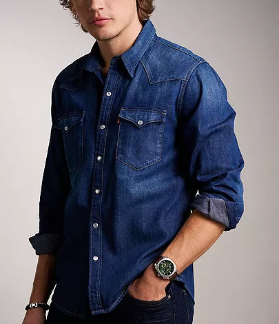 Fossil Machine Chronograph watch worn on wrist with denim shirt