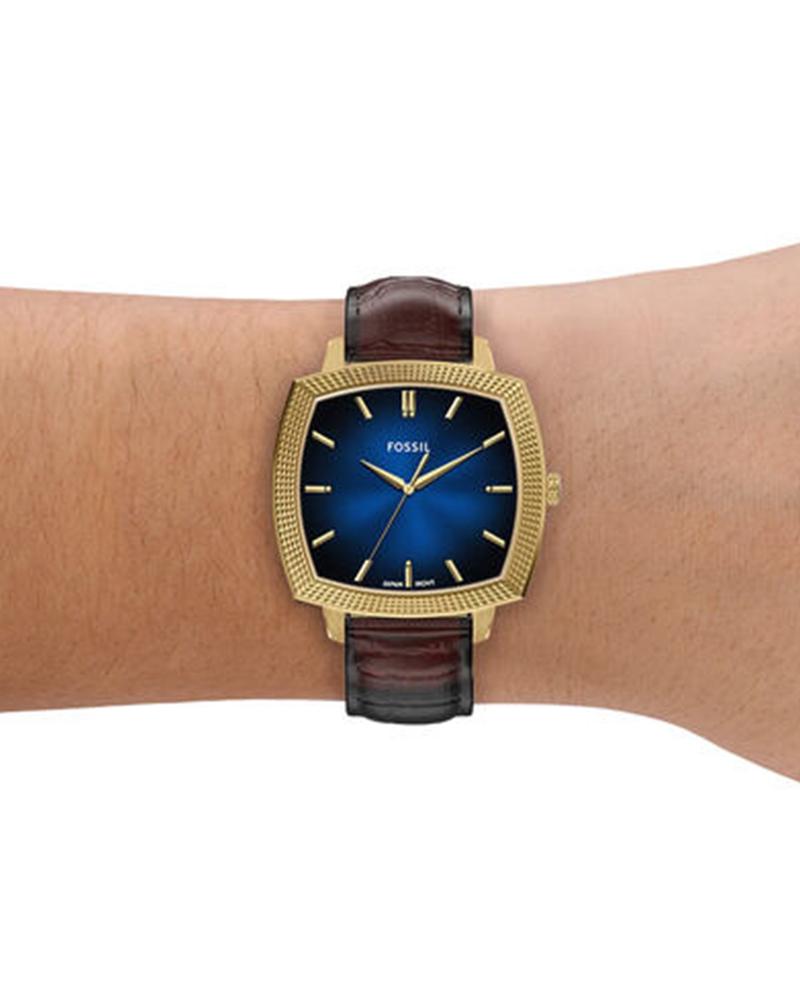 Fossil Machine Luxe watch worn on wrist showing blue dial and gold-tone case