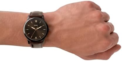 Fossil FS5551 Minimalist watch worn on wrist showing black dial and brown leather strap