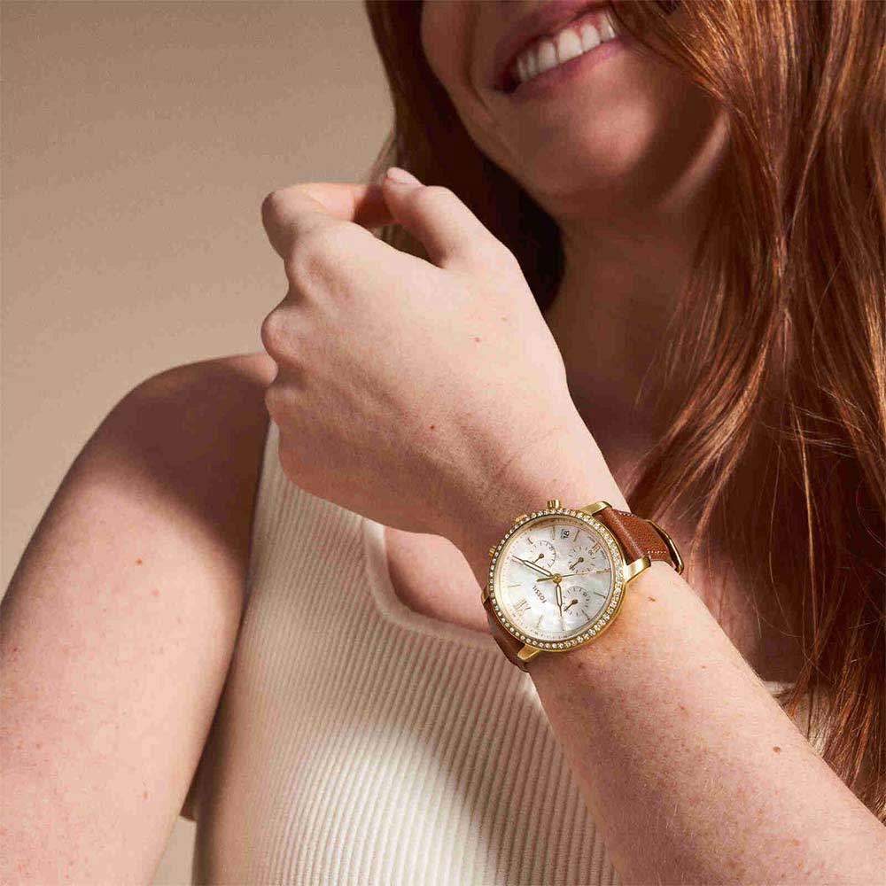 Fossil Neutra Chronograph worn on wrist showing gold-tone case with diamond bezel and brown leather strap