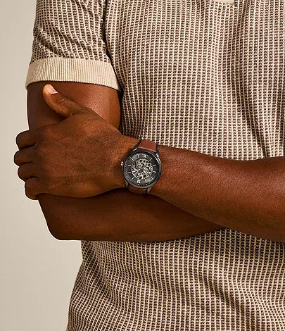 Fossil Neutra automatic watch on wrist with amber leather strap