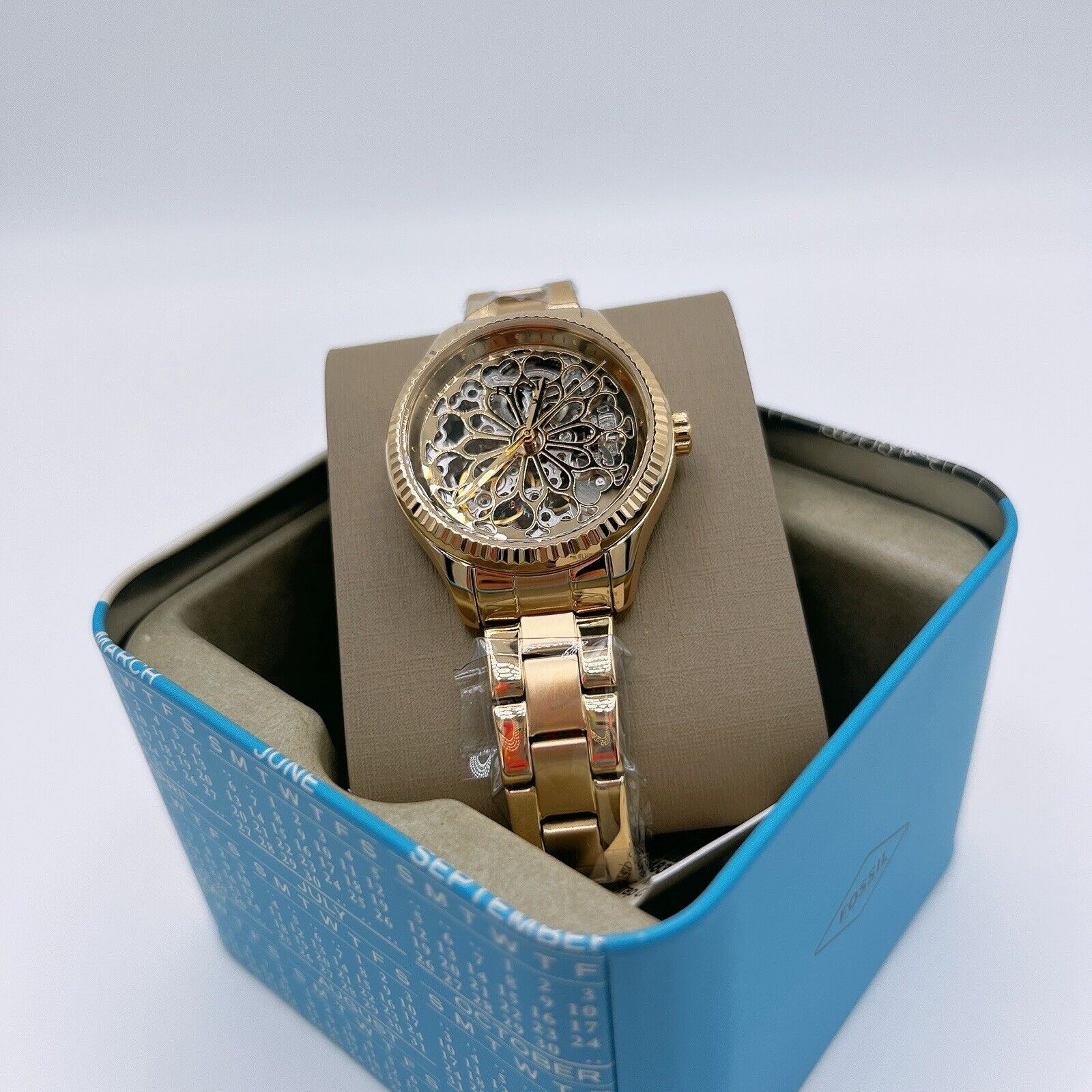 Fossil Rye automatic skeleton watch with gold dial displayed in Fossil box packaging