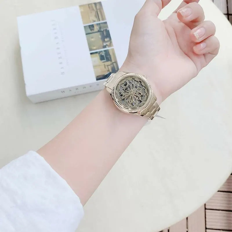 Fossil Rye skeleton gold watch worn on wrist with Fossil branded box in background