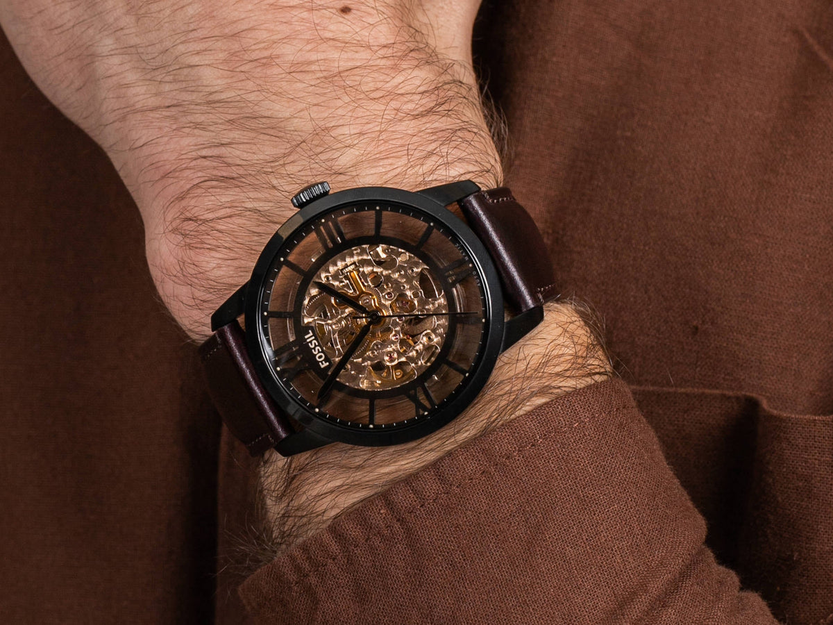 Fossil Townsman automatic skeleton dial watch worn on wrist with brown leather strap