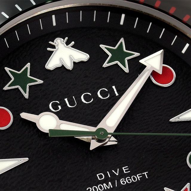 Dial detail of Gucci Dive showing bee and star motifs, GUCCI text, and 660FT water resistance marking