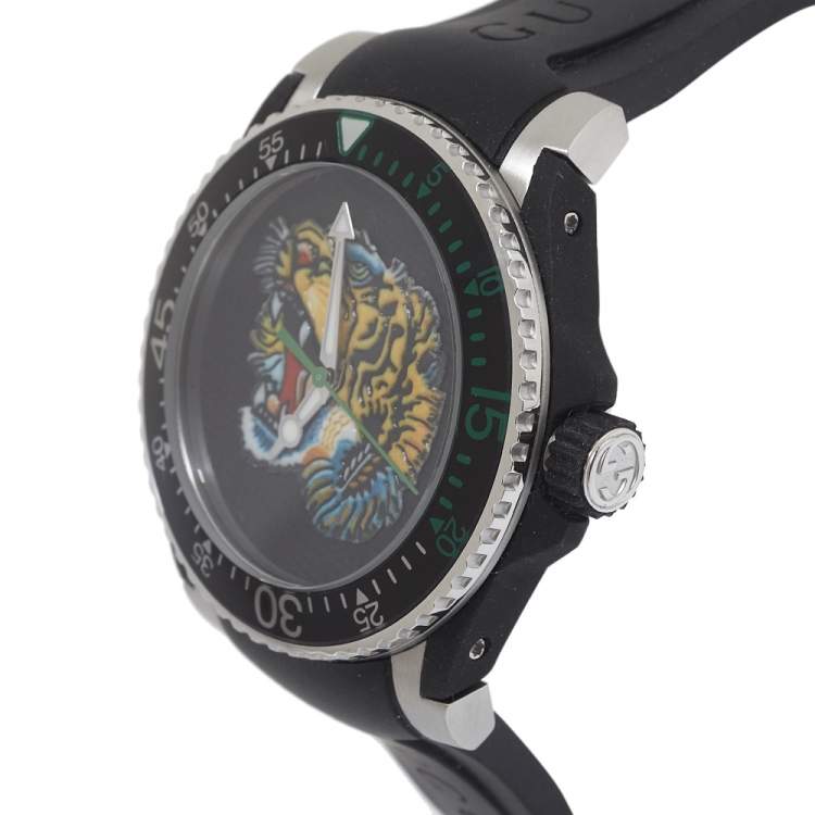 Gucci Dive watch side angle view showing stainless steel case, black rubber strap, and tiger dial detail