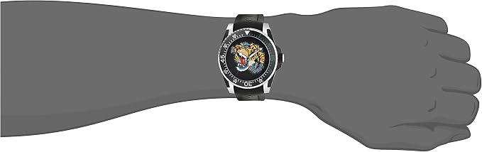 Gucci Dive watch worn on wrist showing black dial with tiger motif and stainless steel case