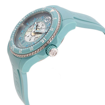 Gucci Dive aquamarine watch angled showing dial and bezel with rhinestones