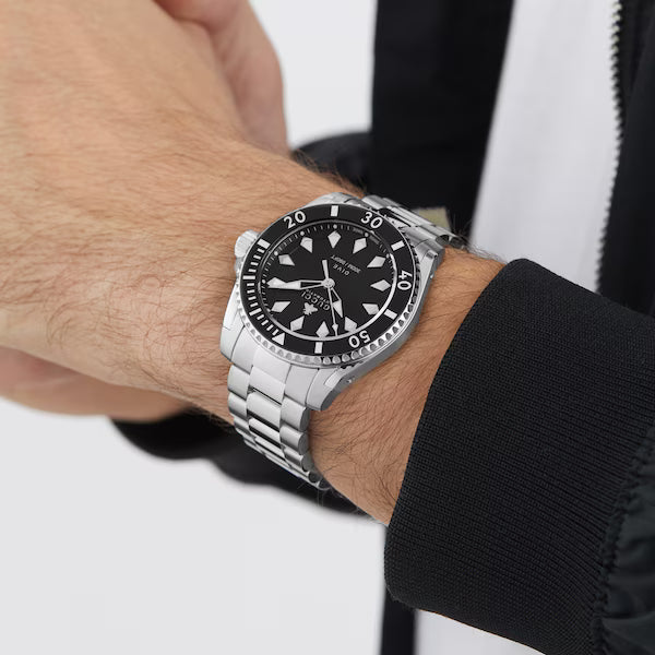 Gucci Dive automatic watch on wrist showing case and strap detail on male model