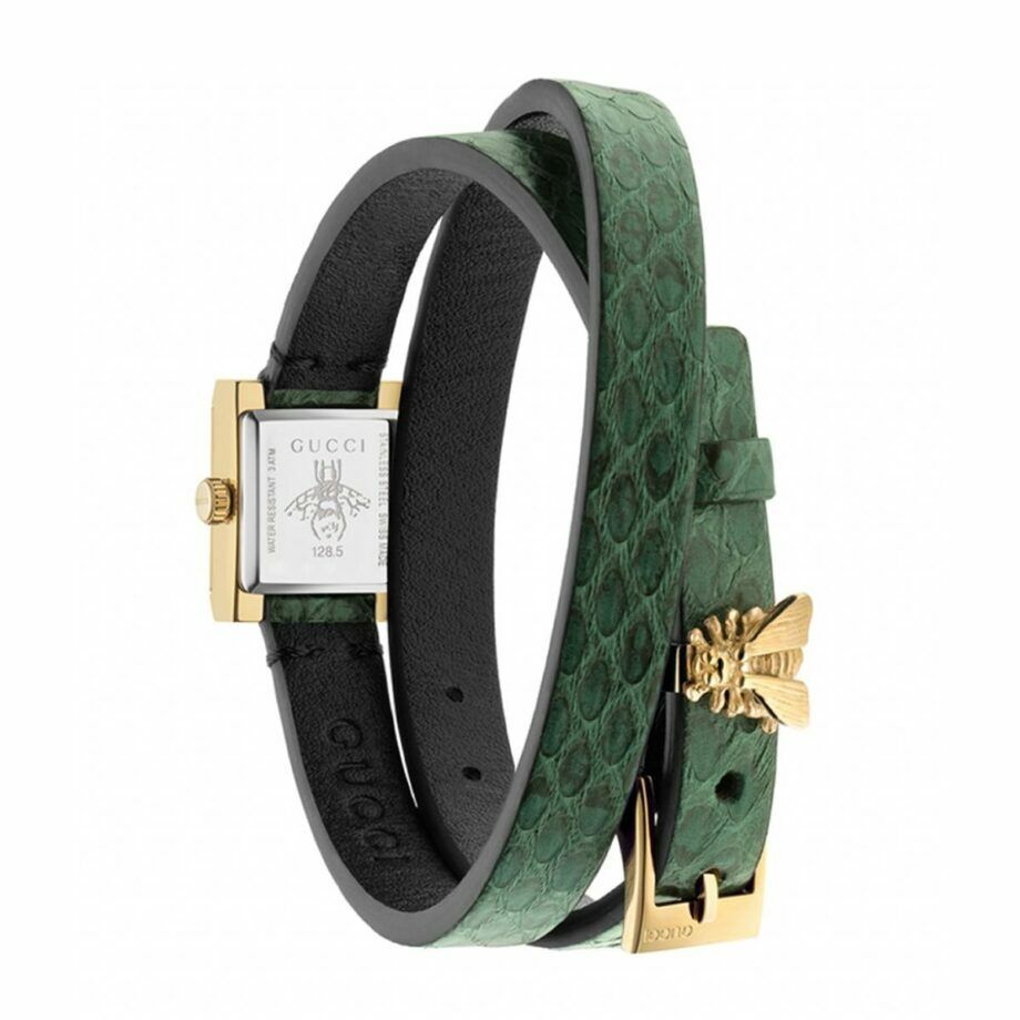 Gucci G Frame watch worn on wrist showing green quilted leather wrap and gold hardware