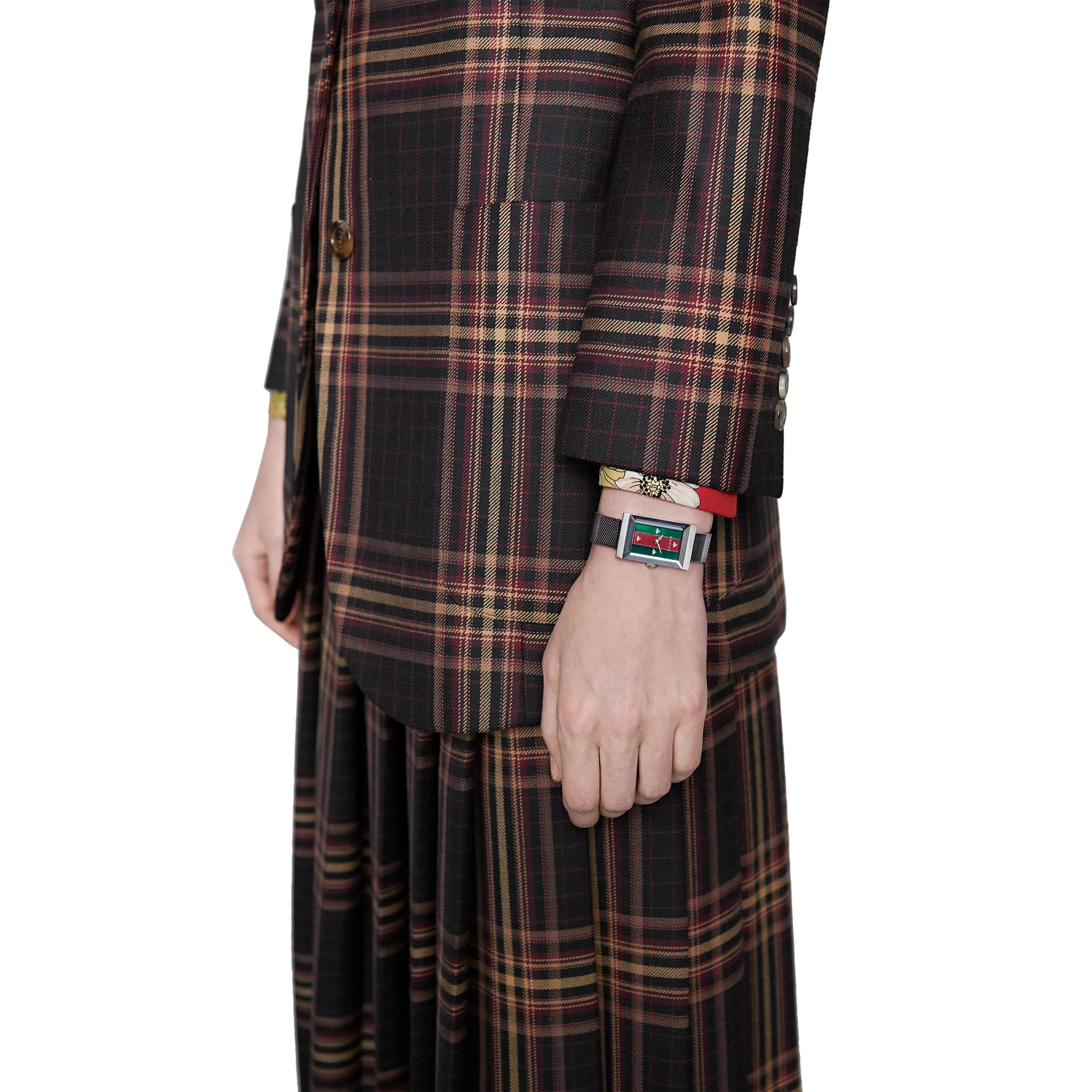 Gucci G-Frame ladies watch worn on wrist with plaid dress