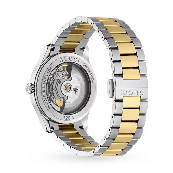 Gucci G-Timeless multibee automatic watch caseback showing movement and two-tone bracelet