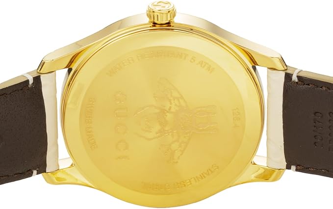 Gold-plated caseback of Gucci G-Timeless watch with engraved details and branding