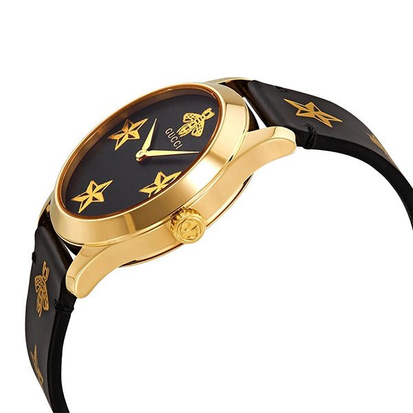 Side angle view of Gucci G-Timeless watch showing gold case profile and black leather strap