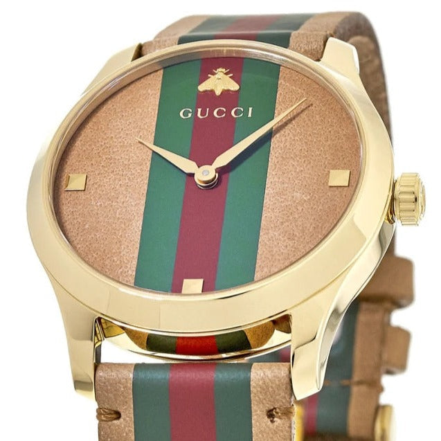 Gucci G-Timeless watch angled view showing tan dial and color-blocked leather strap