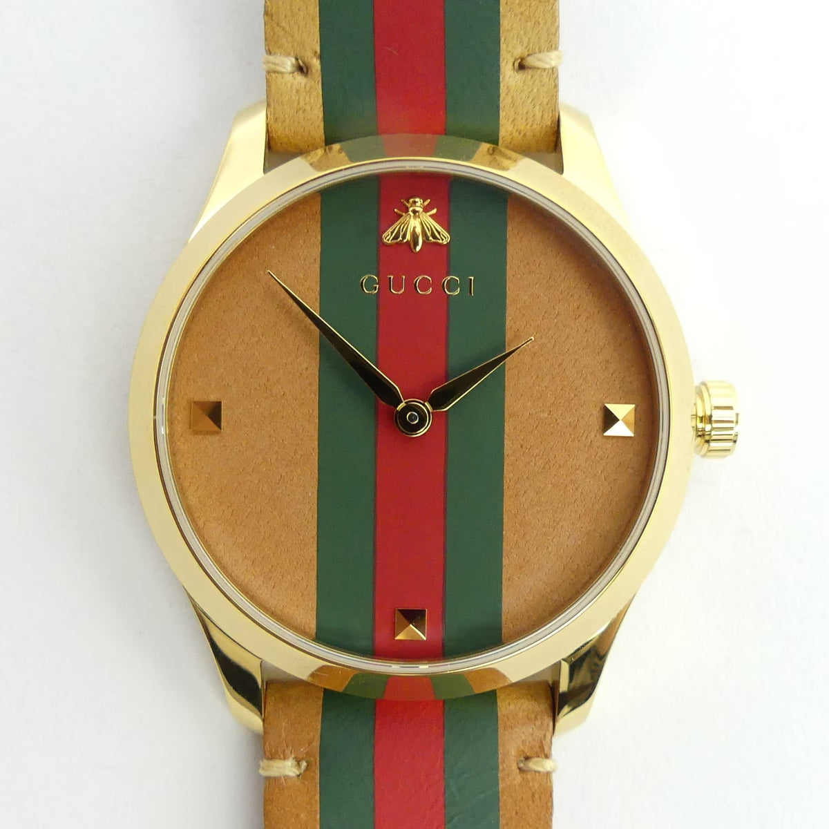 Close-up of Gucci G-Timeless dial with bee logo, green-red-green vertical stripes