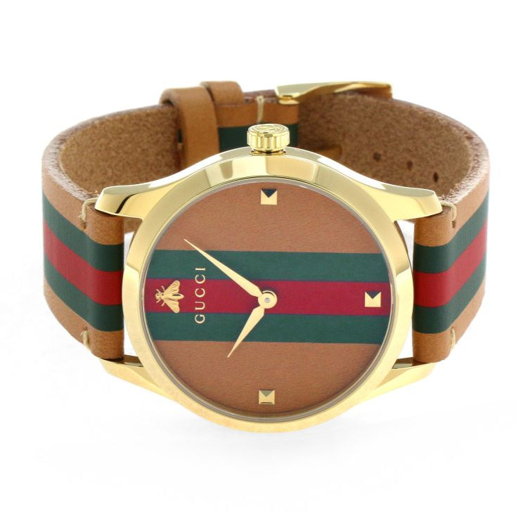 Gucci G-Timeless 38mm watch on wrist showing full face with striped leather band