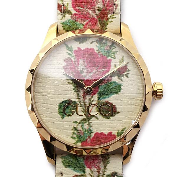 Close-up of Gucci G Timeless floral dial with rose motifs and Gucci branding