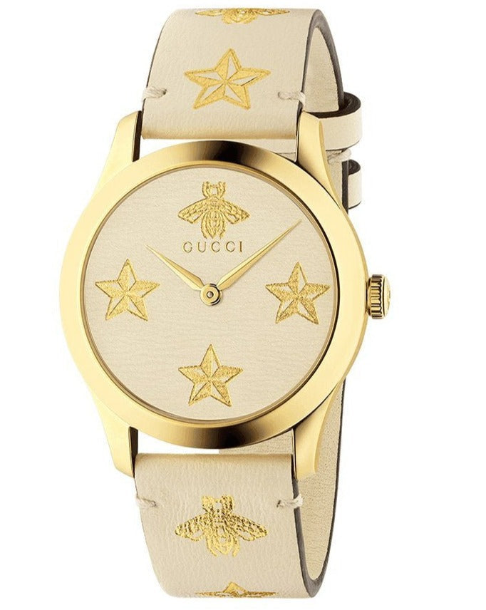 Three-quarter view of Gucci G-Timeless watch with gold-tone case and star-patterned leather strap