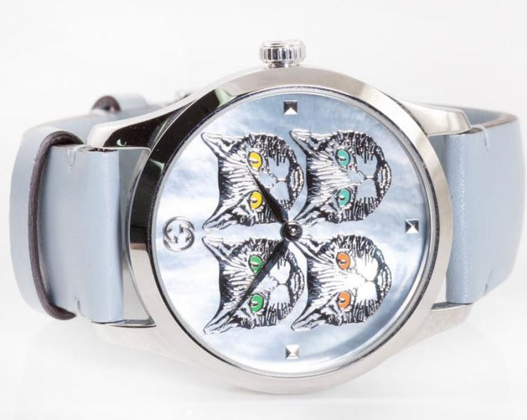 Side angle view of G-Timeless watch with cat face dial and light blue leather strap