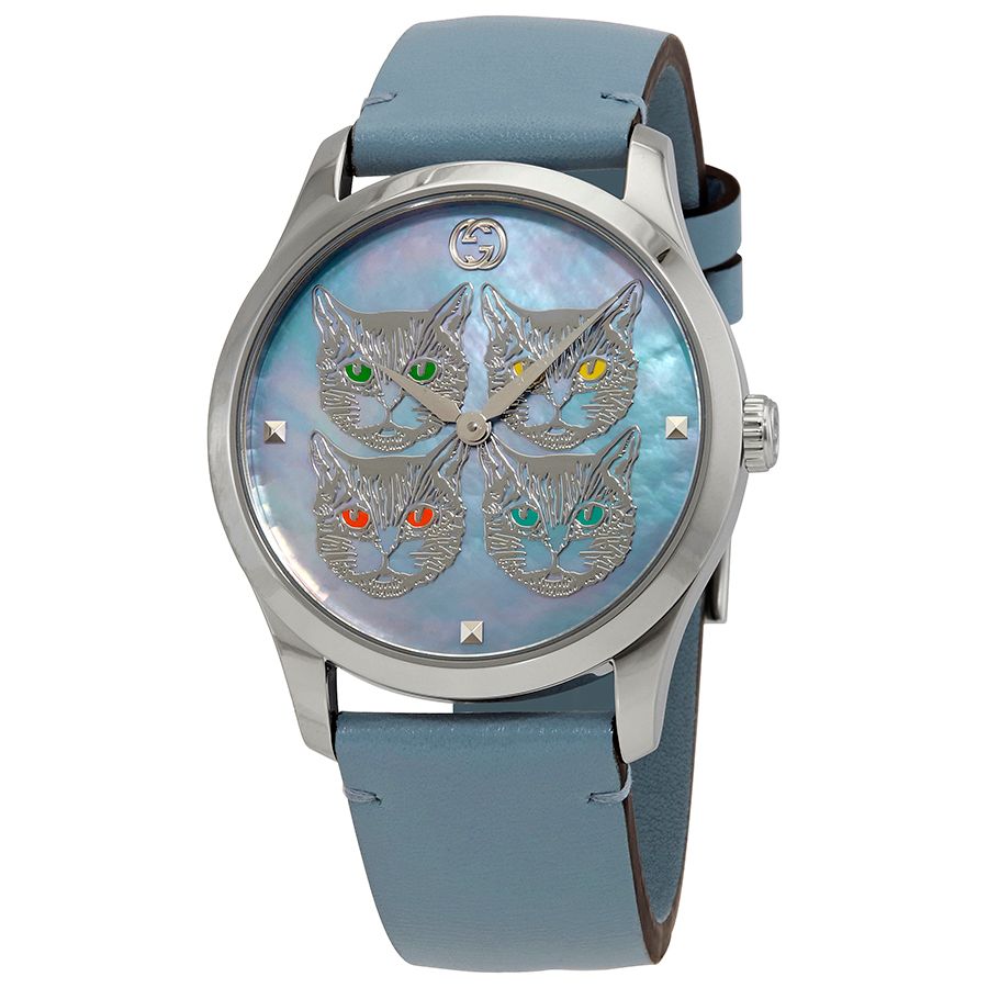 Front view of G-Timeless watch showing embroidered cat faces with green and red crystal details