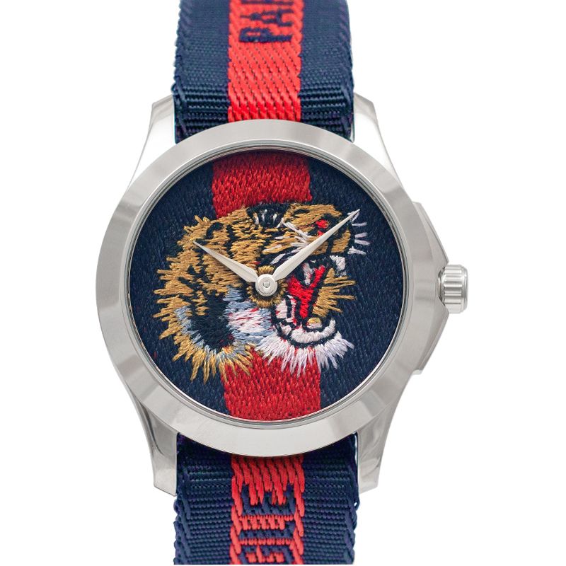 Gucci G Timeless unisex watch front displaying embroidered tiger and red stripe nylon band