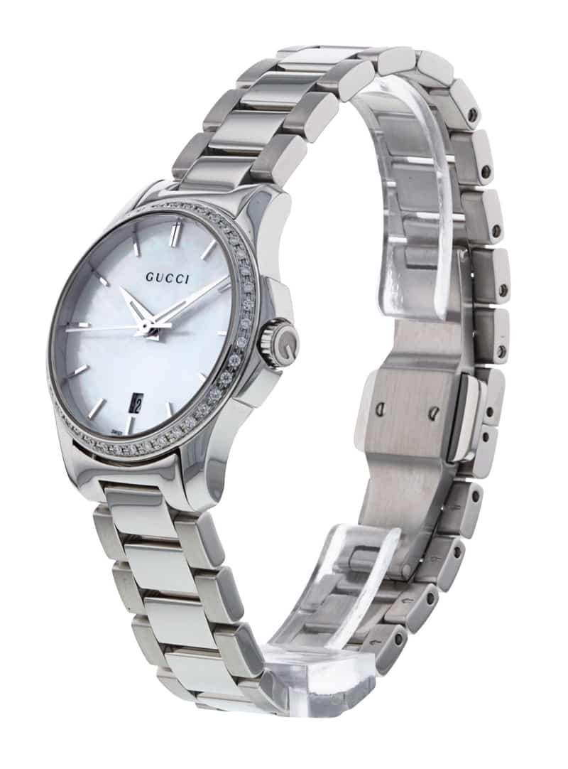 Gucci G-Timeless 27mm watch worn on wrist, showing diamond bezel and stainless steel bracelet