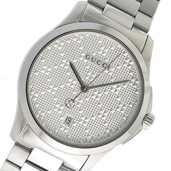 Close-up of Gucci G-Timeless watch dial with geometric pattern and Gucci branding