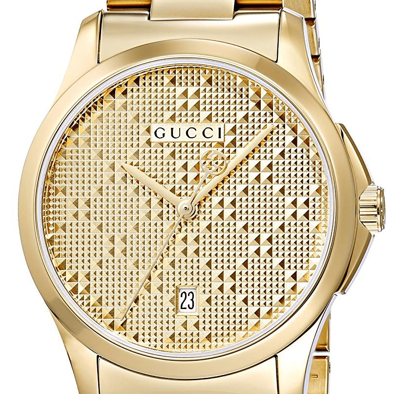 Gucci G-Timeless watch close-up of textured gold dial and hands