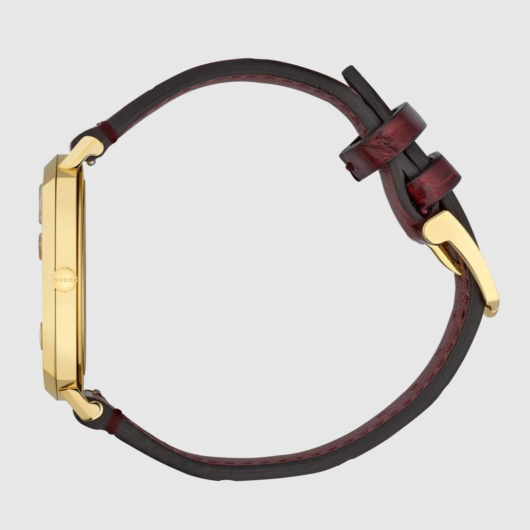 Gucci Grip watch with burgundy leather strap and gold-tone hardware on wrist